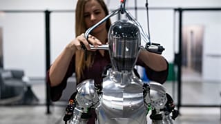 AI engineer Jenna Reher works on humanoid robot Figure 01 at Figure AI's test facility.