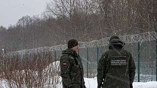 FILE - Members of the Lithuania State Border Guard Service on the border with Belarus 