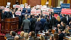 Opposition lawmakers hold banners reading: "Stole the elections" during a Serbia's parliament constitutive session in Belgrade, Serbia, Feb. 6, 2024.