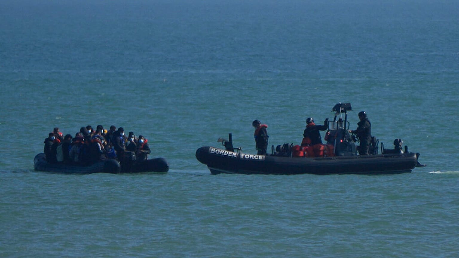 A British Border Force patrol boat intercepts a rib with people thought to be migrants off the the coast at Dungeness, England, Thursday, Sept. 16, 2021.