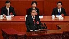 Chinese Premier Li Qiang, center, speaks during the opening session of the NPC at the Great Hall of the People in Beijing, China, Tuesday, March 5 2024
