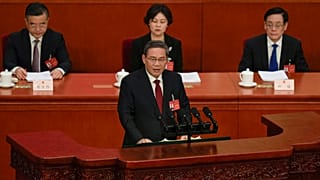 Chinese Premier Li Qiang, center, speaks during the opening session of the NPC at the Great Hall of the People in Beijing, China, Tuesday, March 5 2024