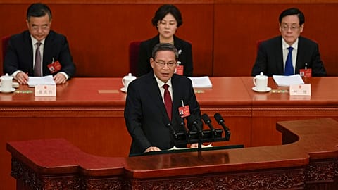 Chinese Premier Li Qiang, center, speaks during the opening session of the NPC at the Great Hall of the People in Beijing, China, Tuesday, March 5 2024