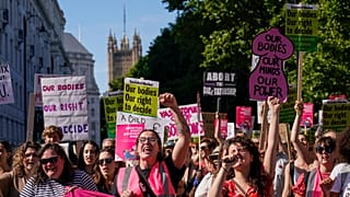  Demonstrators hold placards as they attend a march in support of the Abortion Rights group, in London, on July 9, 2022.