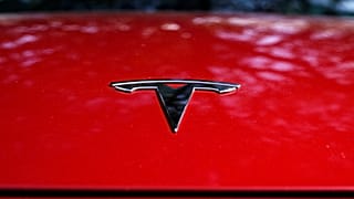 A Tesla logo is seen on a vehicle on display in Austin, Texas, Wednesday, Feb. 22, 2023. 