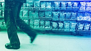 A convenience store customer walks past a shelf of salty snacks in Boston, July 2005