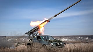 A multiple launch rocket system based on a pickup truck fires towards Russian positions at the front line, near Bakhmut, Donetsk region, Ukraine, Tuesday, March 5, 2024. 