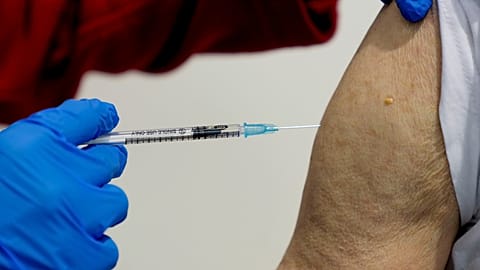 File photo shows a 87-year-old man getting his booster shot at the vaccination center in Frankfurt, Germany, Thursday, Nov. 11, 2021. 