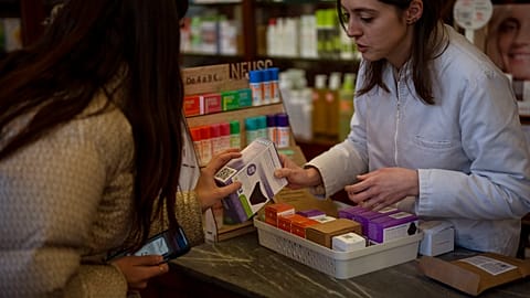 A woman receives an underwear for periods free of charge at a pharmacy in Barcelona, Spain, Tuesday, March 5, 2024.