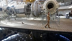 Moskova yakınlarındaki Rus Kozmonotlar Eğitim Merkezi'nde yer alan Uluslararası Uzay İstasyonu maketinin önünden geçen bir Rus mühendis (arşiv)