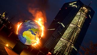 A makeshift globe burns in front of the ECB in Frankfurt, Germany, as activists protest against the bank's climate policy, Oct. 21, 2020. 