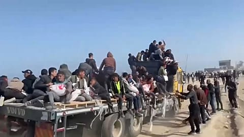 Gazans chase humanitarian aid convoys in Gaza, Wednesday, March 6, 2024.