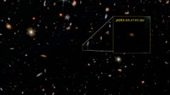 Imagem JWST em falsa cor de uma pequena fração do campo GOODS Sul, com JADES-GS-z7-01-QU em destaque. 