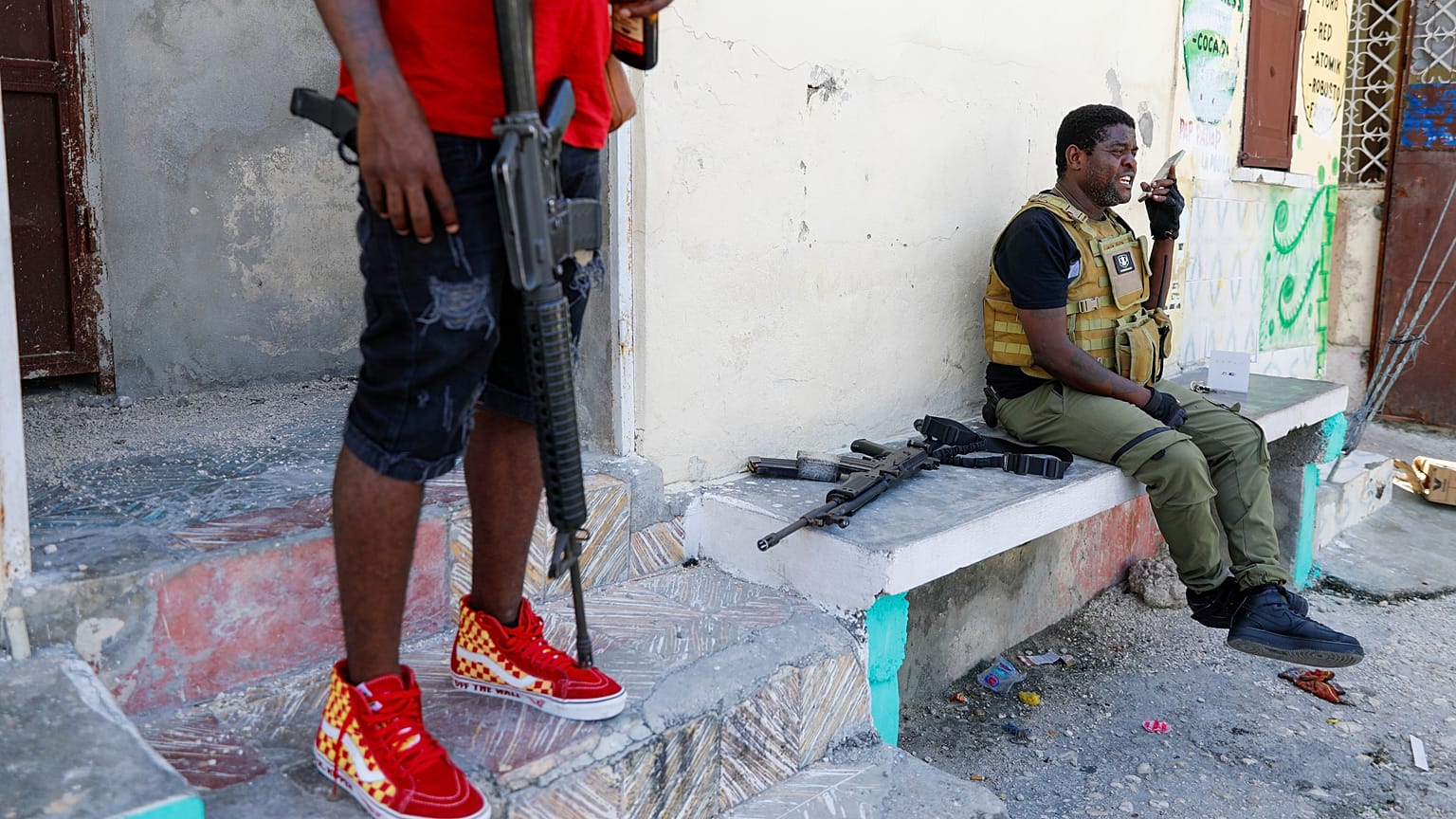 Barbecue, the leader of the "G9 and Family" gang, speaks on a cell phone after addressing journalists in the Delmas 6 neighbourhood of Port-au-Prince in Port-au-Prince, Haiti.