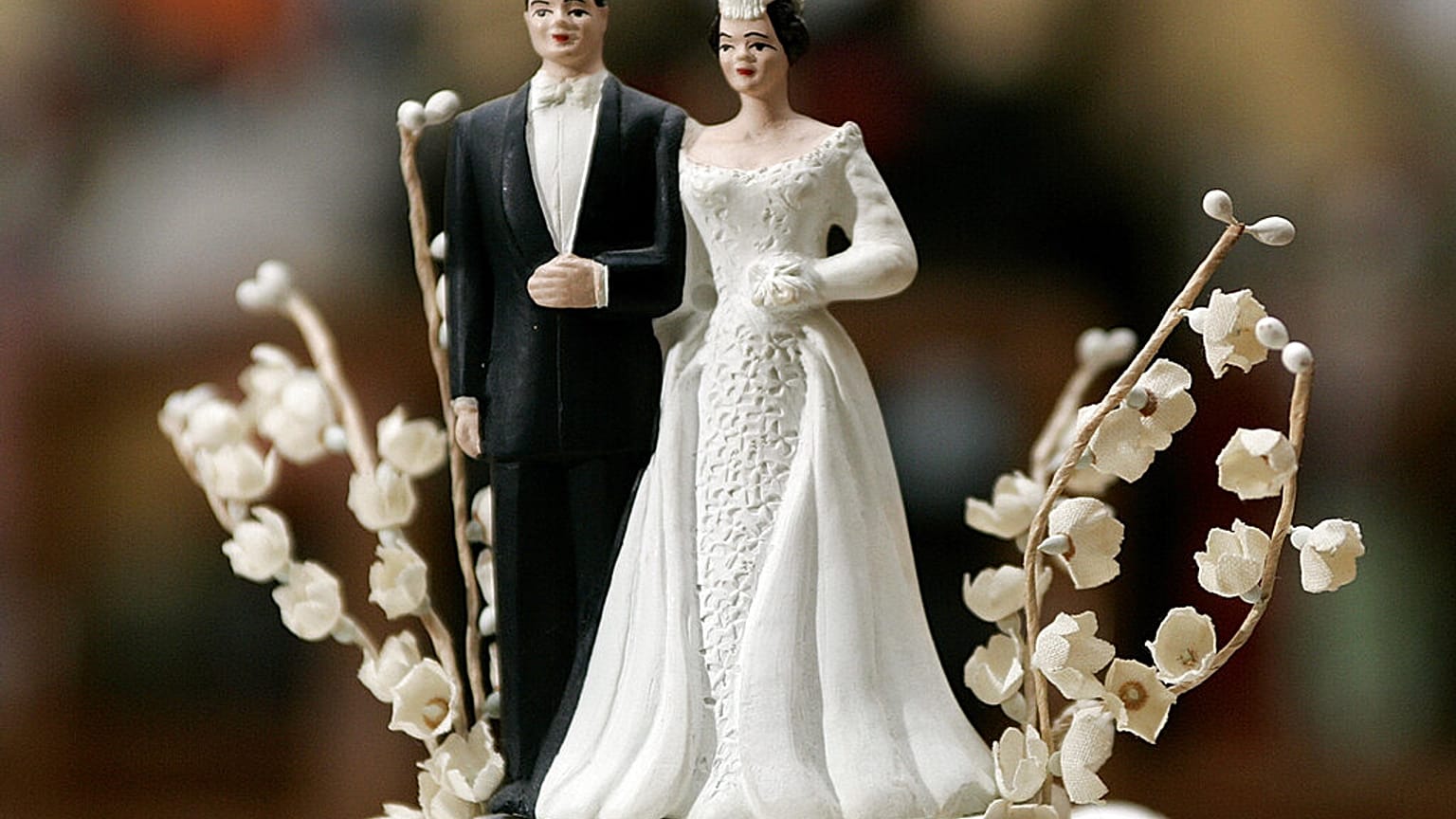 Leann and Bob Adams' bride and groom figurines on top of their 50-year-old wedding cake top photographed in their home Friday morning 