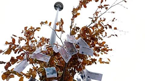 Fake 350 million pound notes hang from a "Magic Money Tree" outside the Houses of Parliament in London Tuesday, Jan. 7, 2020