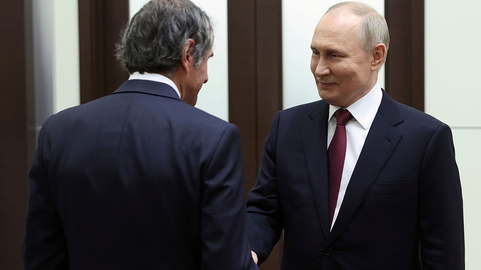 Russian President Vladimir Putin, right, and International Atomic Energy Agency (IAEA) Director General Rafael Mariano Grossi shake hands during their meeting in Sochi, Russia
