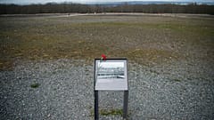 A flower is attached to an information board  near Weimar, Germany, Sunday, April 10, 2022.
