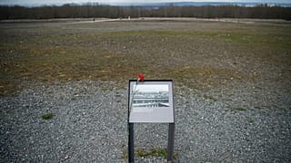 A flower is attached to an information board near Weimar, Germany, Sunday, April 10, 2022.