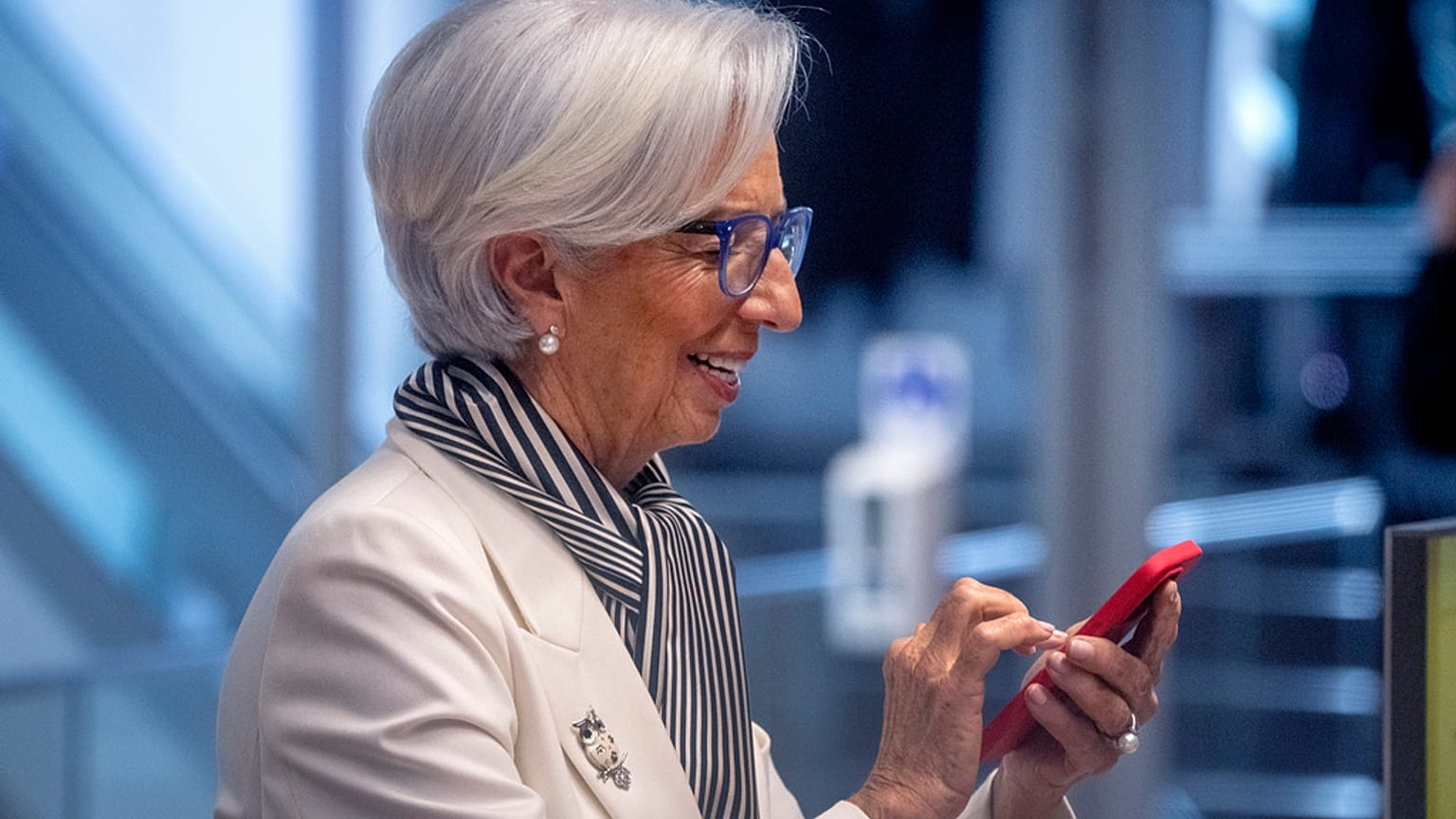 President of European Central Bank, Christine Lagarde, holds a mobile device prior to a press conference after an ECB's governing council meeting in Frankfurt, Germany.