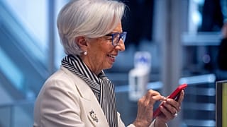 President of European Central Bank, Christine Lagarde, holds a mobile device prior to a press conference after an ECB's governing council meeting in Frankfurt, Germany.