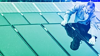 A man cleans rooftop solar panels in Berlin, 2007