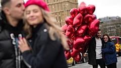 Couples pose for a photograph during the Valentine's Day in London, Wednesday, Feb. 14, 2024. 