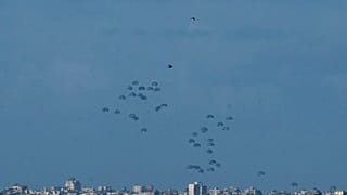Parachutes drop supplies into the northern Gaza Strip, as seen from southern Israel, Thursday, March 7
