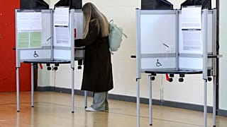 A woman votes in a referendum on the proposed changes to the wording of the Constitution relating to the areas of family and care.