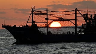 The sun rises while a suspected Chinese militia ship blocks Philippine coast guard ship, not shown, in the disputed South China Sea Tuesday, March 5, 2024.