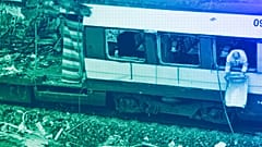 A Spanish railway worker cleans up debris from of a destroyed train at Madrid's Atocha railway station, March 2004