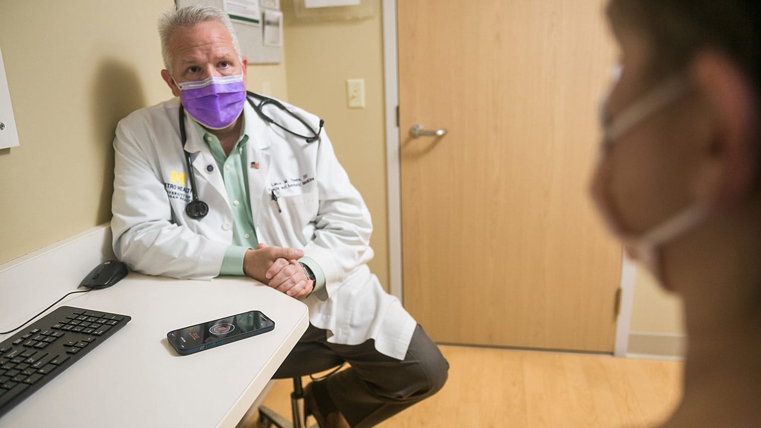 Dr Lance Owens demonstrates the use of an AI tool on a smartphone.