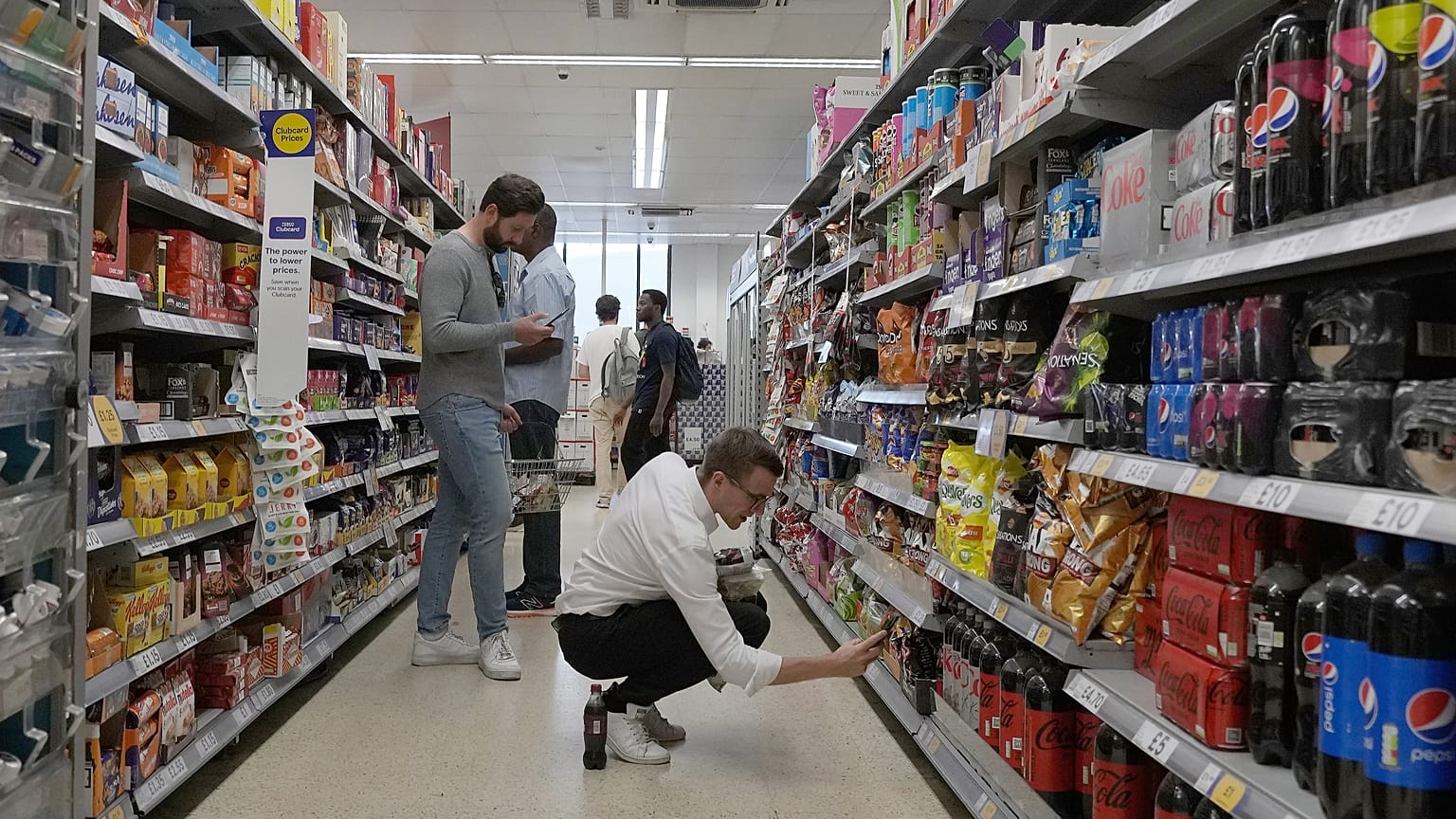 Shoppers buy food in a supermarket in London, Wednesday, Aug. 17, 2022. 