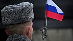 A honour guard soldier holds a rifle with a Russian flag mounted on a gun's bayonet at the monument of the Heroic Defenders of Leningrad in St.Petersburg on 27 January 2024.