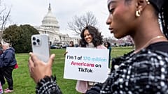 TikTok users monitor voting at the Capitol in Washington, as the House passed a bill that would lead to a nationwide ban of the popular video app.