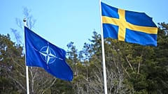 The NATO flag, left, is raised next to the Swedish flag during a ceremony at the Musko navy base Stockholm, Monday, March 11, 2024. 