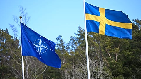 The NATO flag, left, is raised next to the Swedish flag during a ceremony at the Musko navy base Stockholm, Monday, March 11, 2024. 