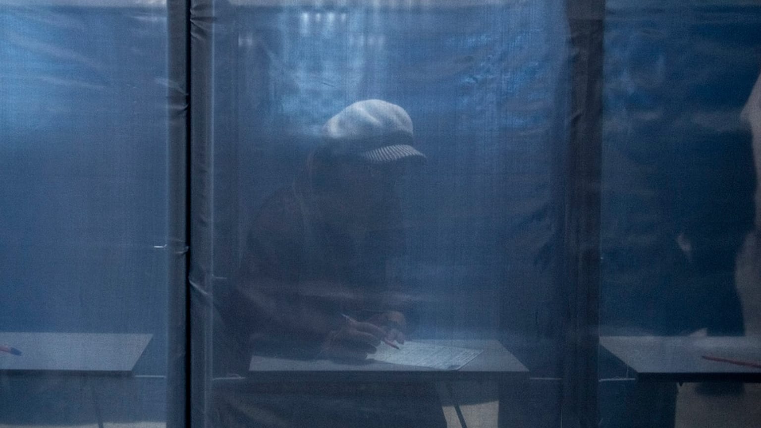 A woman fills in a ballot at a polling station during a presidential election in Russian-controlled Donetsk region of eastern Ukraine, Friday, March 15, 2024.