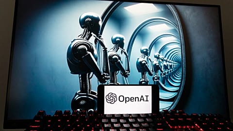 The OpenAI logo is seen displayed on a cell phone with an image on a computer screen generated by ChatGPT's Dall-E text-to-image model.