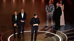 James Wilson, from left, Leonard Blavatnik, and Jonathan Glazer accept the award for "The Zone of Interest' for Best International Feature