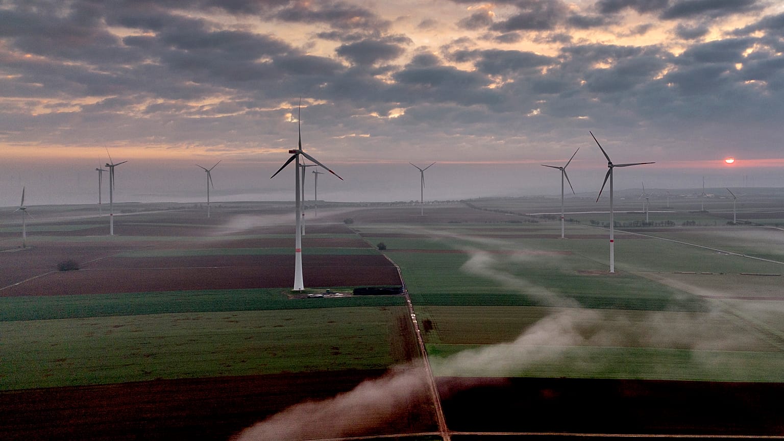 Fog floats over a wind energy plant near Stetten, some 20 kilometres north of Kaiserslautern, Germany, as the sun rises on Tuesday, March 19, 2024.