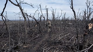 A Ukrainian soldier walks in position on the front-line near Klishchyivka, Donetsk region, Ukraine, Monday, March 18, 2024. 