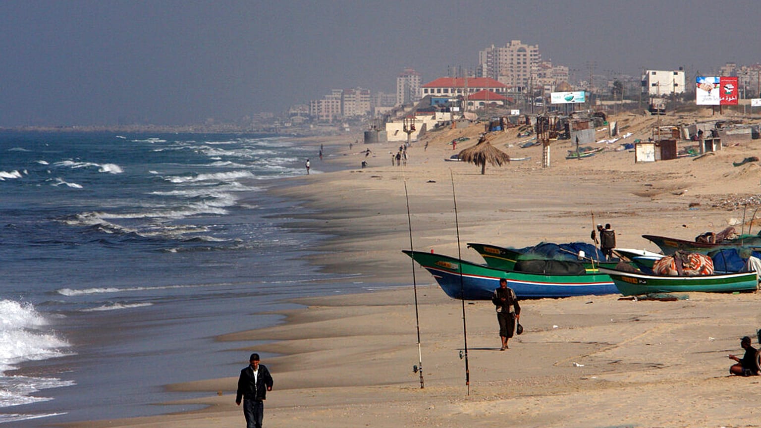 Palestinian fishermen walk on the beach in Gaza City, Wednesday, Nov. 26, 2008. 