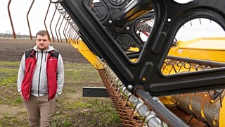 Piotr Korycki, a 34-year-old Polish farmer, walks past machinery on his farm in Cywiny Wojskie, Poland, on Monday March 18, 2024.