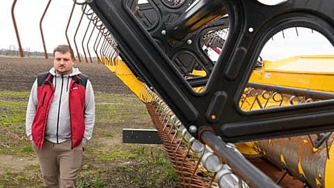 Piotr Korycki, a 34-year-old Polish farmer, walks past machinery on his farm in Cywiny Wojskie, Poland, on Monday March 18, 2024.