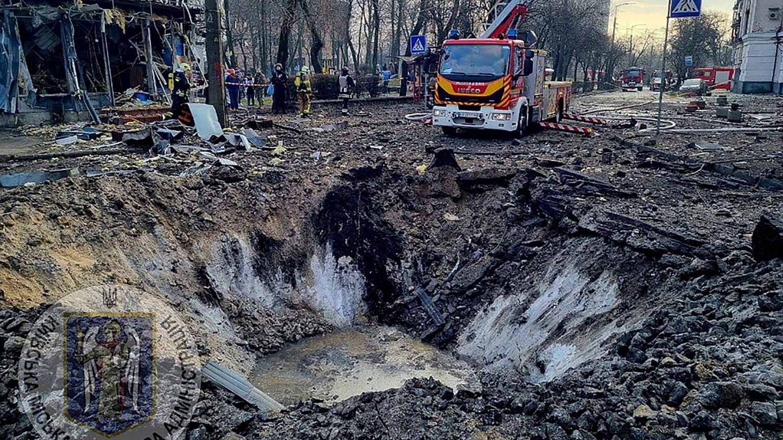 In this photo provided by Serhii Popko, the head of the city's military administration, firefighters work at the site after Russian attacks in Kyiv, Ukraine, march 21