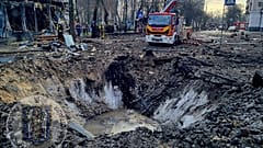 In this photo provided by Serhii Popko, the head of the city's military administration, firefighters work at the site after Russian attacks in Kyiv, Ukraine, march 21