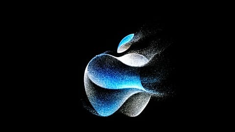 The Apple logo is shown on a screen during an announcement on the Apple campus.