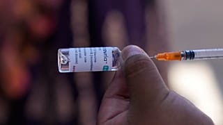 FILE - A healthcare worker prepares a dose of the AstraZeneca COVID-19 vaccine during a door-to-door vaccination campaign, in El Alto, Bolivia.
