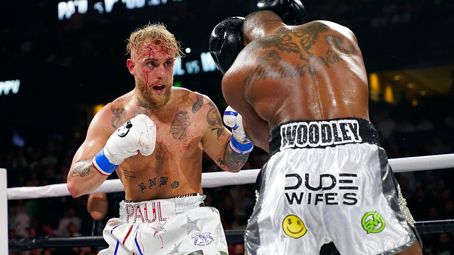 Jake Paul, left, punches Tyron Woodley during the second round of a Cruiserweight fight Sunday, Dec. 19, 2021,